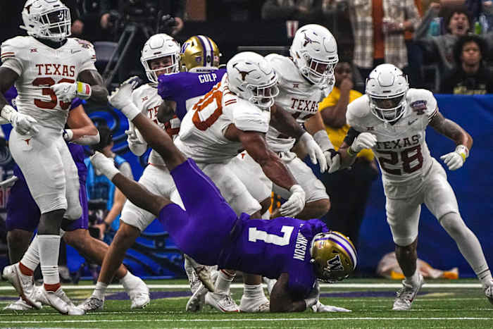 Texas Longhorns defensive lineman Byron Murphy II (90) throws Washington running back Dillon Johnson (7) to the ground during the Sugar Bowl College Football Playoff semifinals. © Aaron E. Martinez/American-Statesman / USA TODAY NETWORK